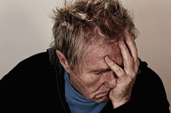 Man with head held in his hands