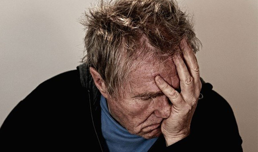 Man with head held in his hands